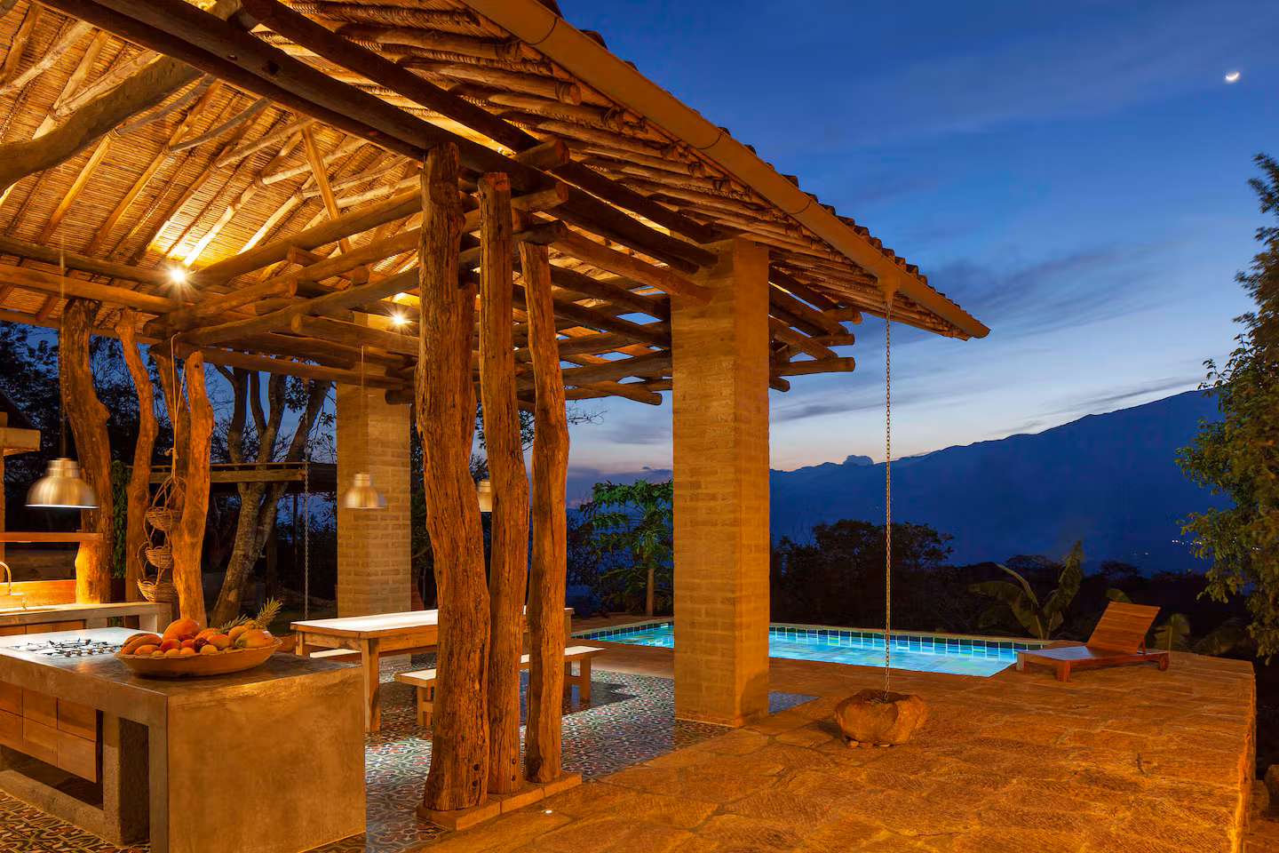 Infinity-edge mosaic pool overlooking the Barichara valley at sunset