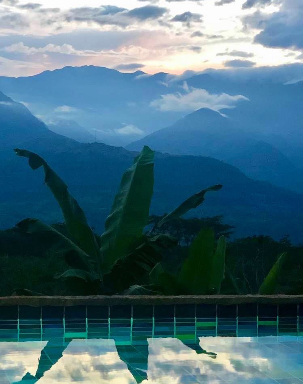 Pool edge reflecting the mountains at dusk