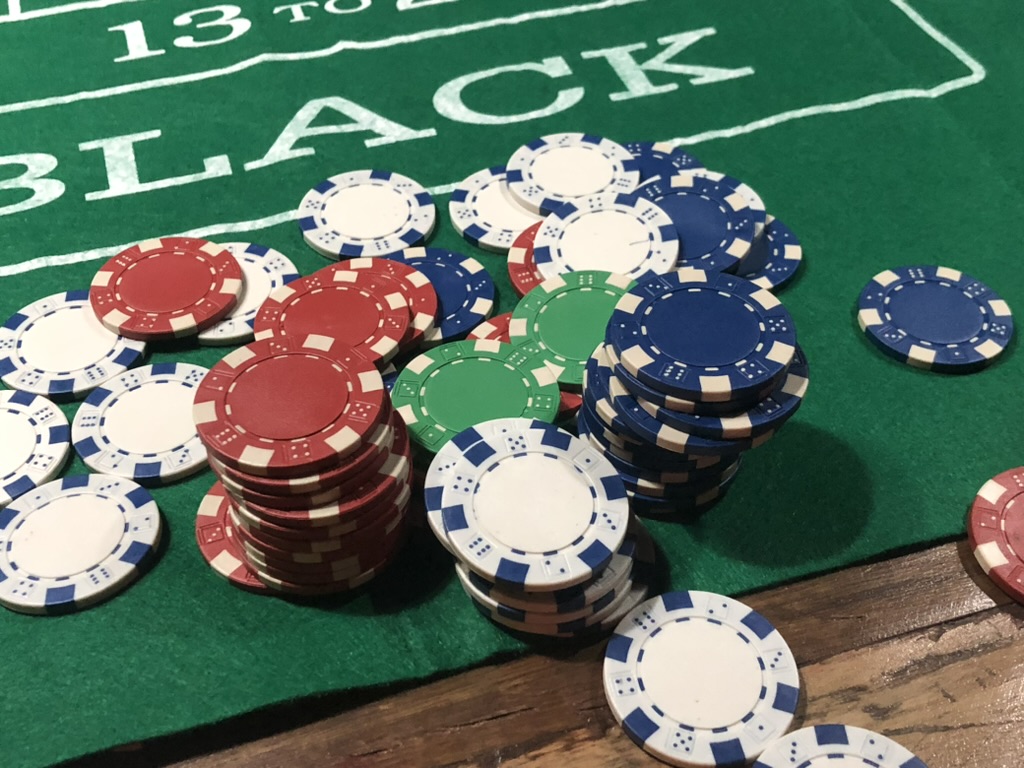 Poker chips laid out on the green baize of the games table