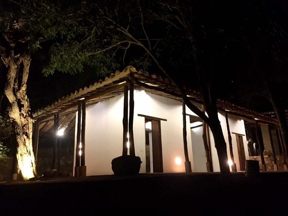 The whitewashed finca lit at night beneath its clay-tile roof and timber posts