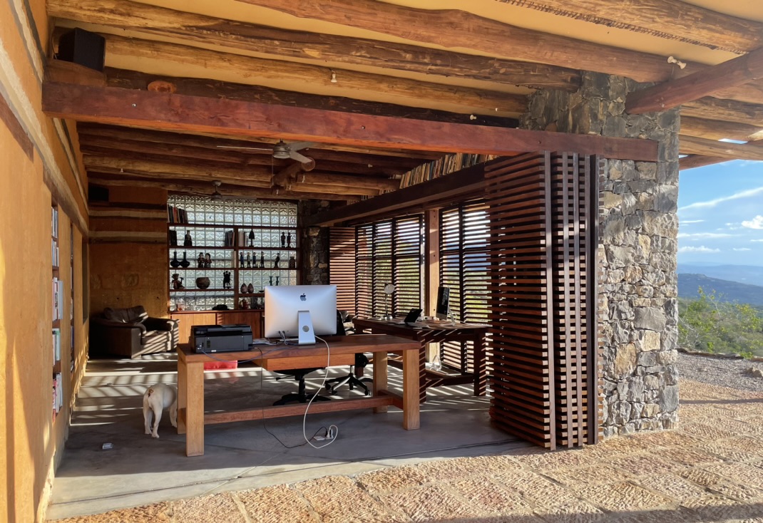 Stone column framing the desk and the mountain view beyond