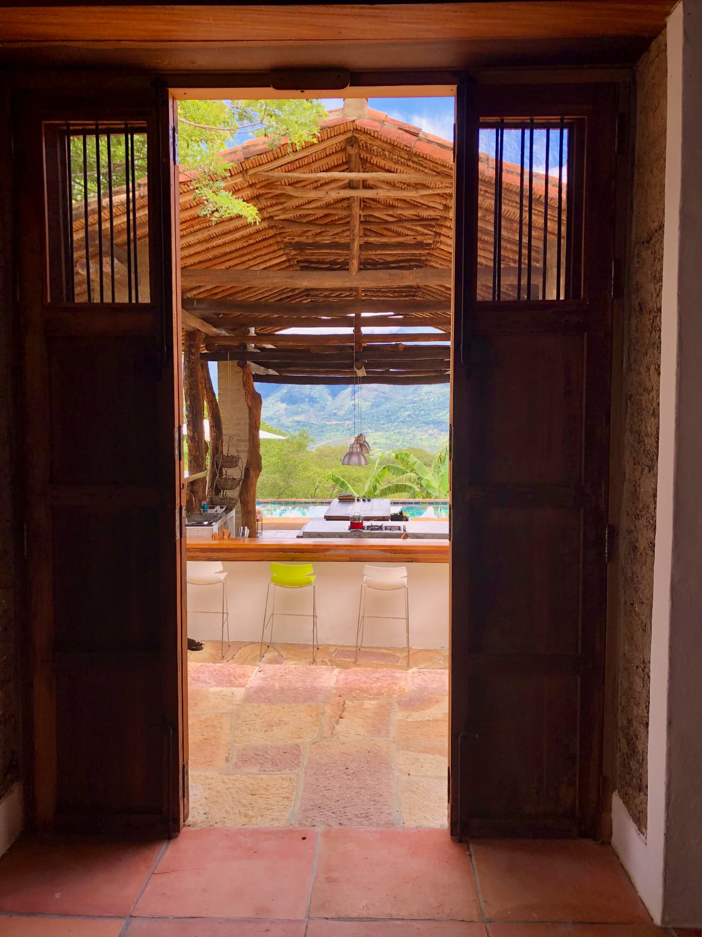 Mountain view through the timber doors past the pool bar