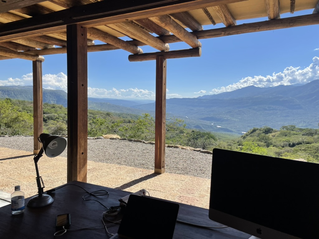 Desk under the pergola with an uninterrupted view across the valley and mountains